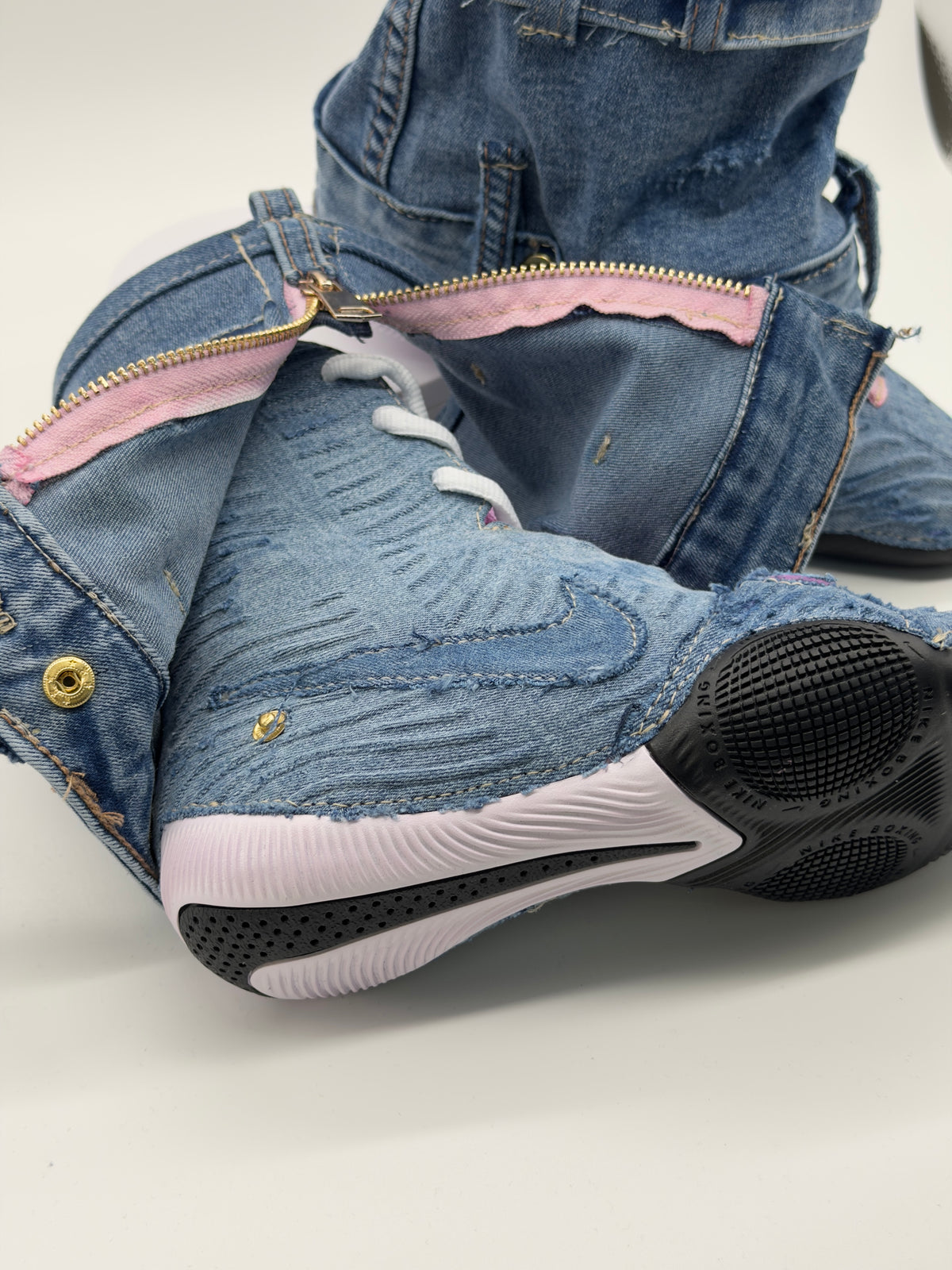 Close-up of the denim reconstruction, stitched panels and sole on a HyperKO 3 boot